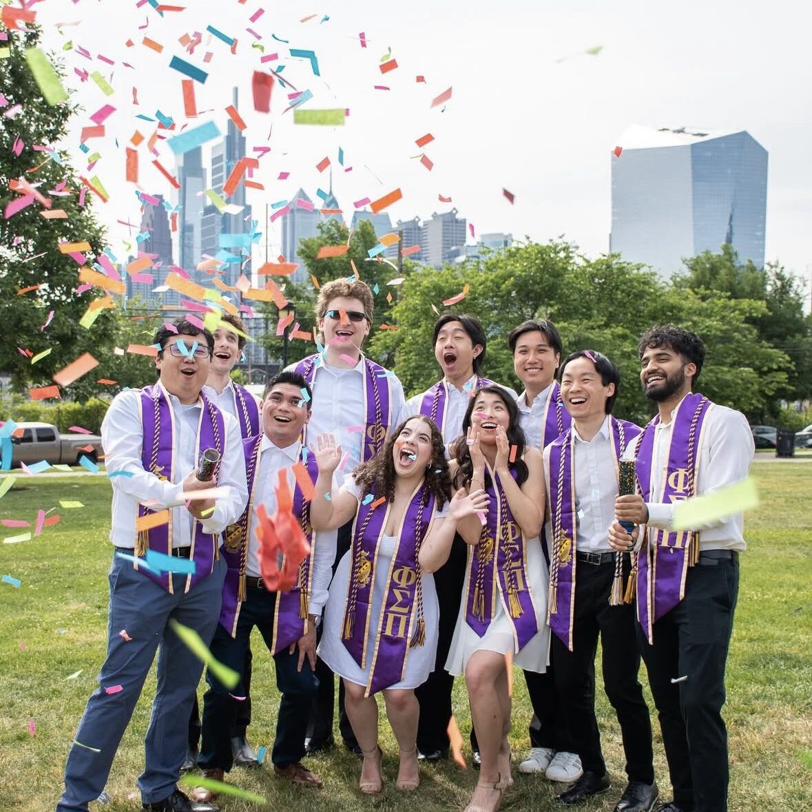 Graduates throwing confetti