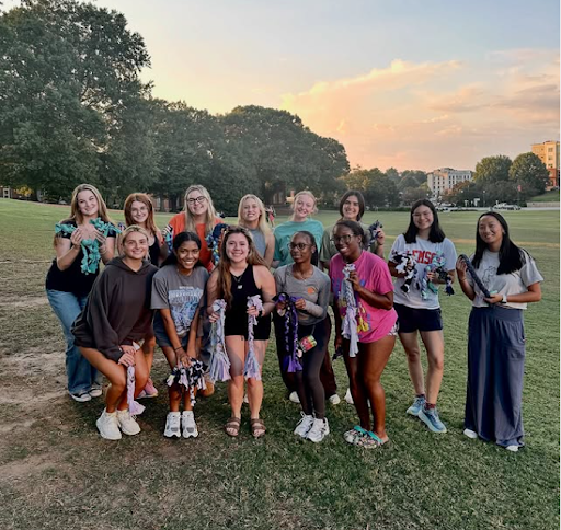 Members holding homemade dog toys