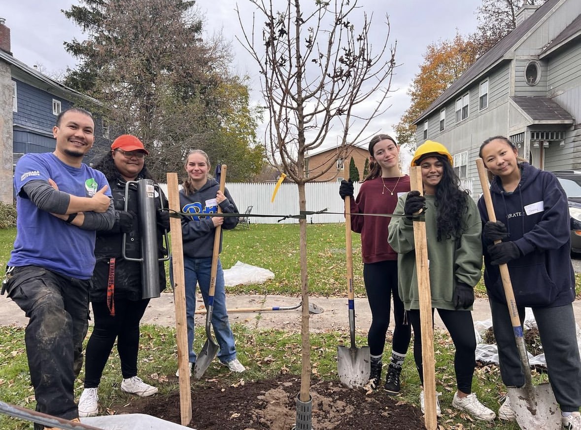 Members at Syracuse University plant trees.