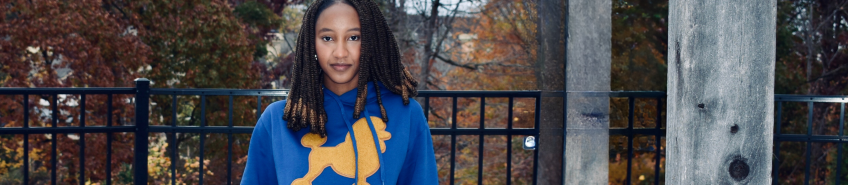 Adira Abdullah poses for a photo in Sigma Gamma Rho Sorority, Inc. merch